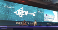 Two people on stage having a discussion at the GEN-E European Entrepreneurship Festival,