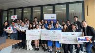 Group of students holding FedEx awards