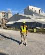 John Hargrove standing outside buildings on a driveway in hard hat and high-vis vest.