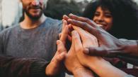 Group of people holding hands.