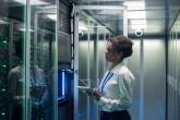 Data center worker observing servers