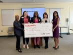 KeyBank and YWCA leadership shown with the grant check.