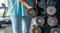 Woman picking up weights at the gym