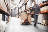 Worker pulling boxes in a warehouse
