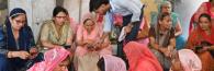 Group of Indian women looking at their phones