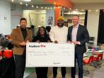 4 people holding a KeyBank Check