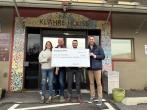 KeyBank and The Next Door Team shown with Grant Check.
