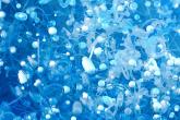 Group of floating "PFAS" with a blue background