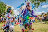 Native Americans wearing traditional dress 