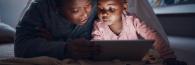 Mother and daughter looking at computer screen.