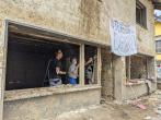 employees rebuilding home destroyed by flooding