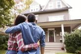 A couple embracing as they look at their new home.