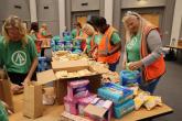 Women packaging menstrual health management supplies 