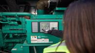 Worker looking at power generation equipment