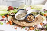 Closeup bowl chia seeds and other healthy foods on a kitchen table.