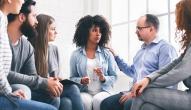 Group of employees supporting a distressed woman in the center