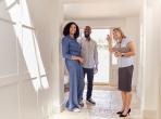 Real estate agent showing a couple a house