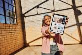 Young person holding a tablet. 