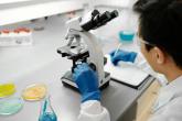 Scientist using microscope in laboratory