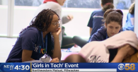 Young women in lanyards working together at a group event