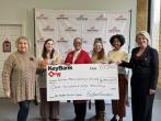 Representatives from KeyBank and Santa Maria Community Services shown with a $150,000 grant check.