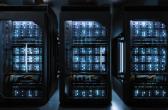 Server racks inside a modern data center, housing high-density computing equipment used for cloud computing and AI workloads.