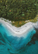 Blue waves crashing into a beach.
