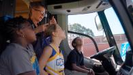 3 kids and an adult inside of a truck