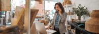 Female business owner talking on a phone.