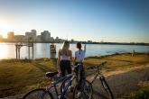 Two people looking at cityscape with bikes next to them