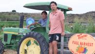 Tankaka Farms fall harvest. Kenny Tankaka shown with a tractor.