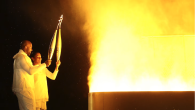 Two people with Olympic torches