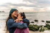 Two people hugging on the beach