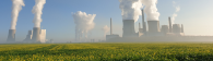 Smoking industrial complex above field