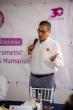 A person stood up talking into a microphone