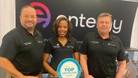 From left, Rivers Frederick, Kya Moller and Dan Boren stood in front of the entergy logo at the WBENC conference