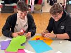 Teenagers shown doing an art project.