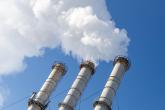 Smoking pipes making clouds against blue sky background