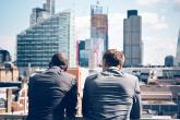 Two businessmen looking at skyline