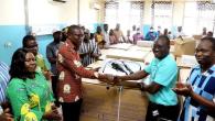 Ghana Medical Help representatives and healthcare workers gather around newly delivered hemodialysis equipment at a hospital in Ghana.