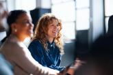 Smiling Colleagues Engaging During an Informal Office Meeting in Brightly Lit Space