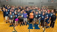 Group of volunteers wearing Motorola shirts standing in gym
