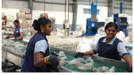 People sorting plastic bottles on a conveyor line.