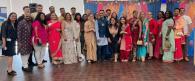 A group posed in AAPI cultural garments