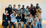 A group of employees holding up a Cadence sign