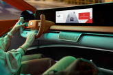 Person driving a car with a screen on the dashboard