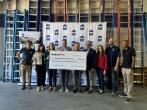 People posing with an oversized check