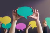 people holding up conversation bubbles 