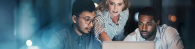 Three people looking at a laptop screen