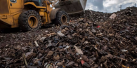 Bulldozer scoops up automotive waste